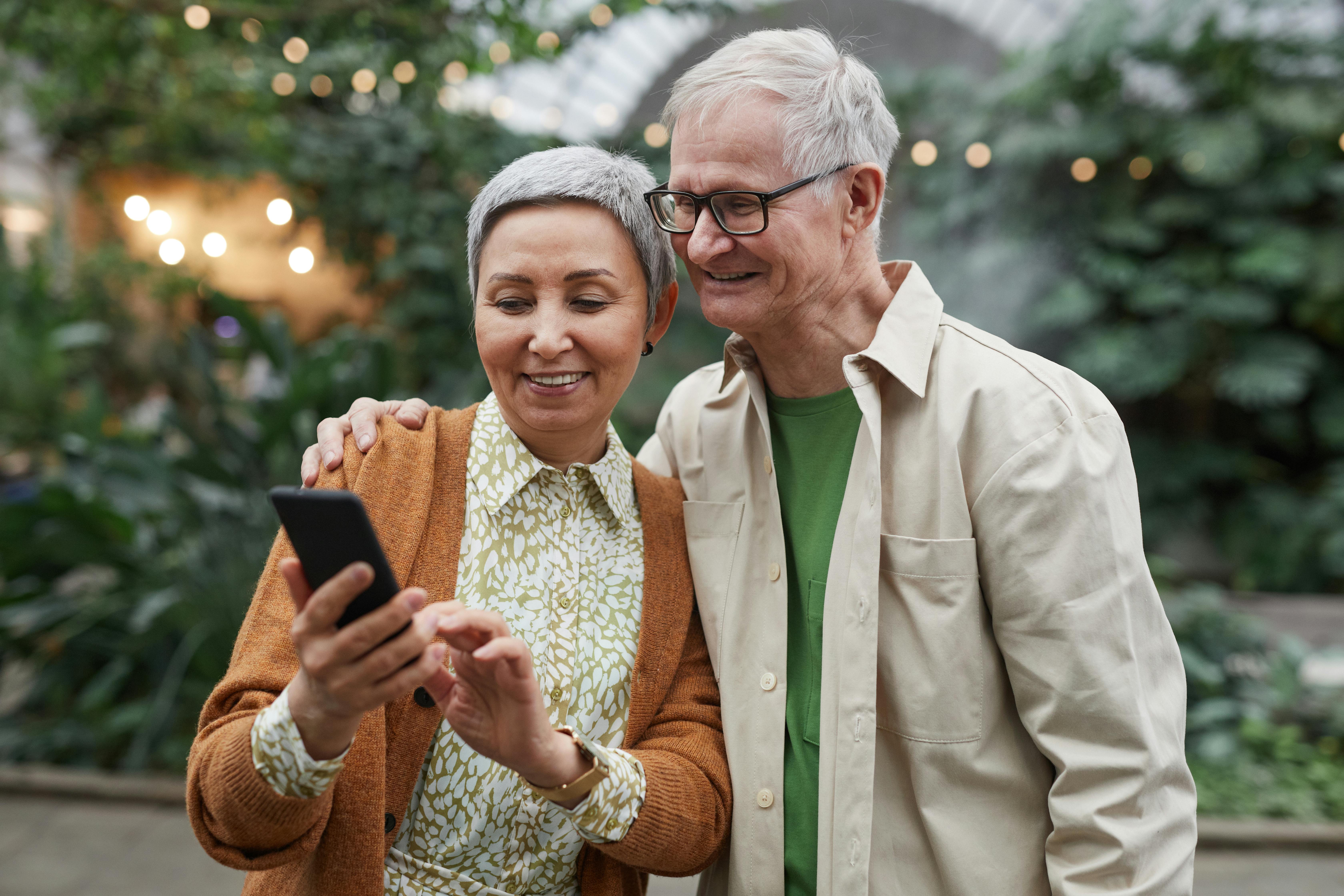 Happy couple reviewing Medicare options with an agent